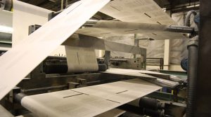 Printed web paper passing through a printing press