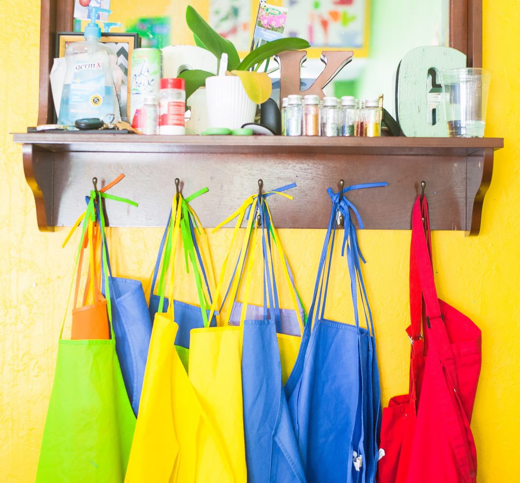 Colourful aprons hanging on a wall